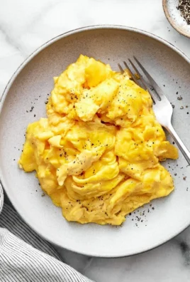 Delicious fluffy scrambled eggs on a plate for breakfast