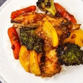 Sheet pan honey garlic chicken with mixed vegetables ready to be served