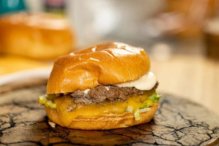 Delicious homemade smash burger on a plate with toppings