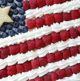 American Flag Fruit Pizza topped with fresh fruits in a star and stripe pattern