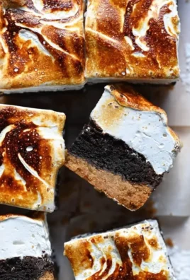 Decadent Brownie Marshmallow Bars topped with gooey marshmallow fluff.