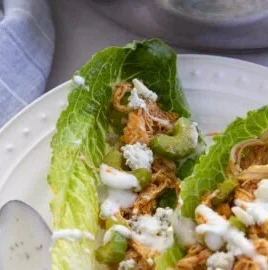 Buffalo Chicken Lettuce Wraps served on a plate with fresh ingredients