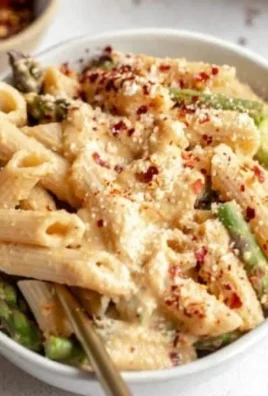 Creamy dairy-free lemon white bean pasta garnished with fresh herbs