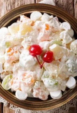 Delicious creamy fruit salad with assorted fresh fruits in a bowl.