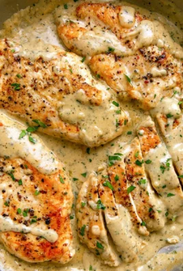 Plate of creamy ranch chicken garnished with herbs