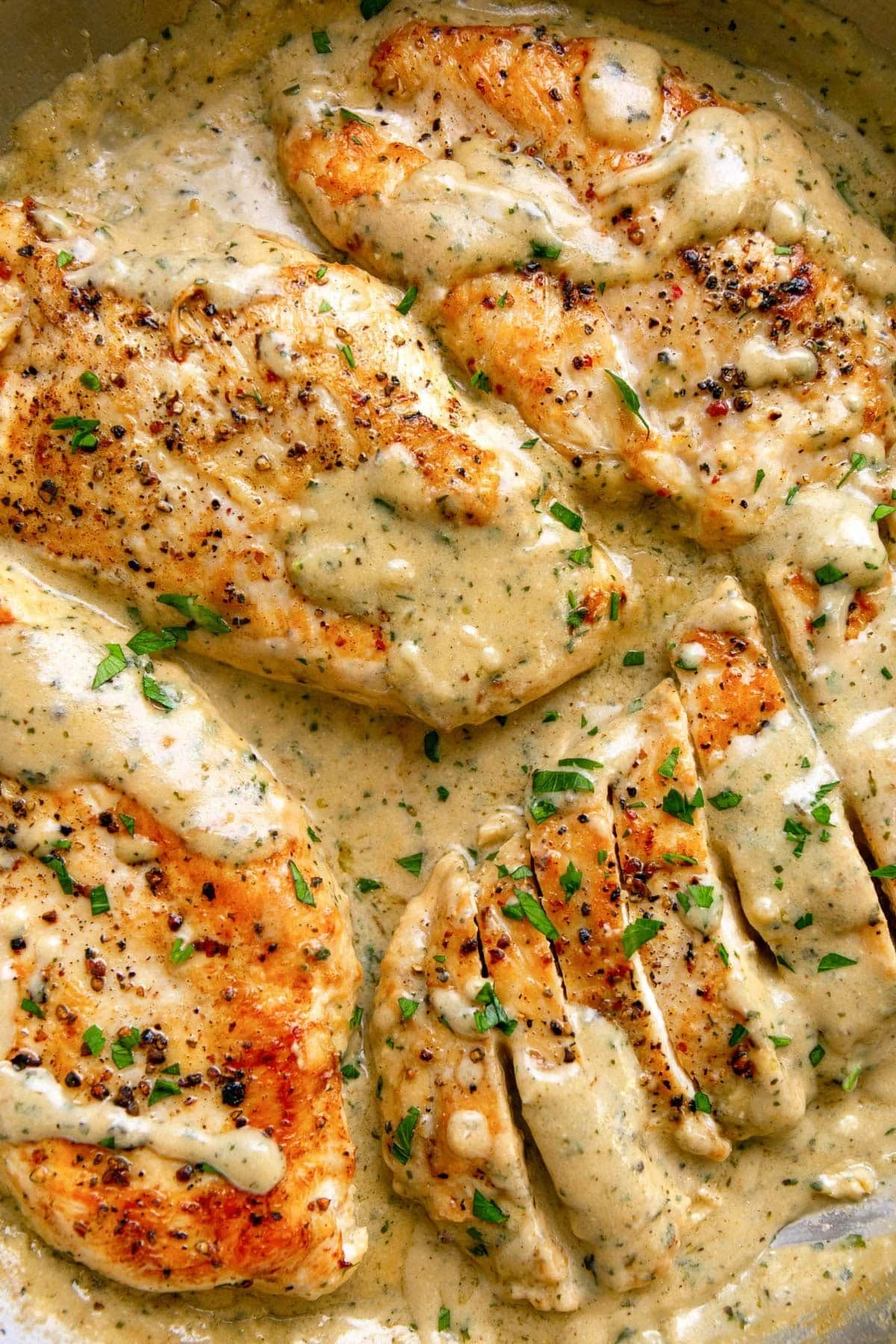 Plate of creamy ranch chicken garnished with herbs