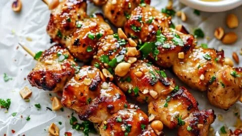 Easy grilled Asian chicken skewers with honey garlic sauce on a serving platter