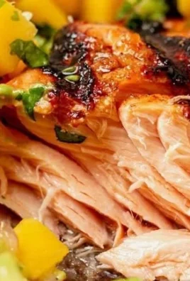 Fresh salmon fillet served with mango salsa on a plate