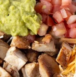 Grilled chicken burrito bowl with rice and beans served in a colorful dish