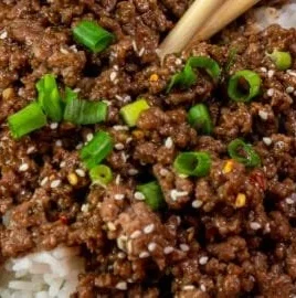 Korean Beef Bowl featuring tender beef, vegetables, and sauces in a bowl.