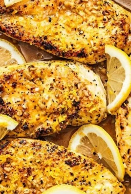 Lemon Pepper Chicken Dinner served on a white plate with herbs and lemon slices.