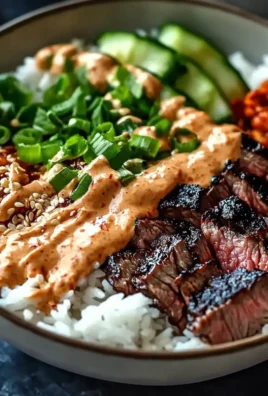 Delicious Korean BBQ steak bowl topped with fresh vegetables and sauce