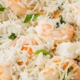 Plate of Parmesan Basil Shrimp with rice garnished with fresh basil