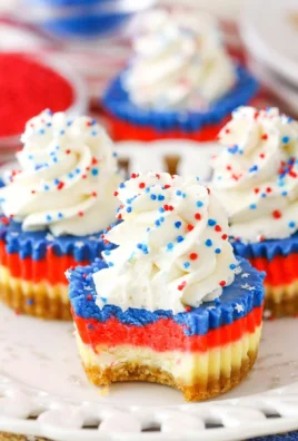 Delicious Red, White and Blue Mini Cheesecakes with festive toppings
