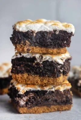 Delicious S'mores Brownies topped with chocolate and marshmallows