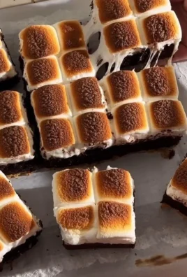 Decadent S'mores Brownies with chocolate, graham crackers, and toasted marshmallows
