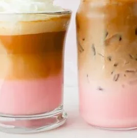 Delicious Strawberry Latte topped with whipped cream and fresh strawberries