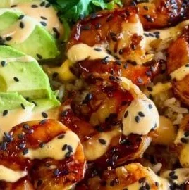 Teriyaki shrimp rice bowl with fresh vegetables and savory sauce