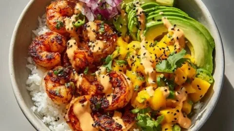 Delicious charred shrimp bowl with avocado and colorful toppings