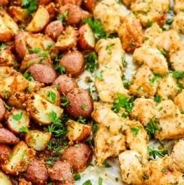 Baked Garlic Parmesan Chicken served with seasoned potatoes on a plate