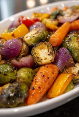Balsamic glazed roasted vegetables on a dish, showcasing vibrant colors and texture.