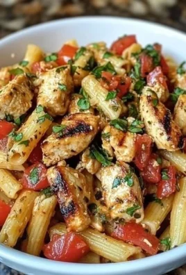 Delicious Bruschetta Chicken Pasta topped with fresh tomatoes and basil