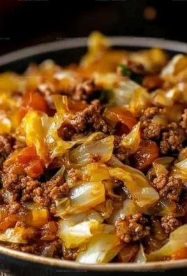 Cabbage and ground beef dish served in a bowl, garnished with herbs.