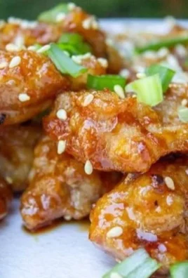 Plate of Chinese Honey Garlic Chicken served with vegetables and rice