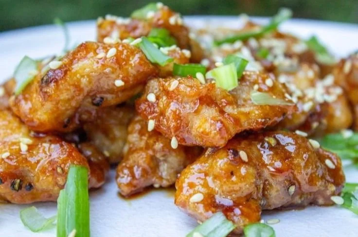 Plate of Chinese Honey Garlic Chicken served with vegetables and rice