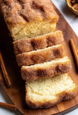 Loaf of cinnamon sugar donut bread with a dusting of sugar on top