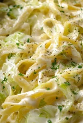 Creamy Alfredo Cabbage Pasta in a bowl garnished with herbs