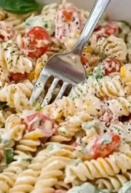 Creamy Italian pasta salad with colorful vegetables and rich dressing.