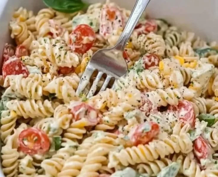 Creamy Italian pasta salad with colorful vegetables and rich dressing.
