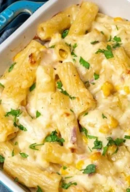 Creamy tuna pasta bake topped with melted cheese and herbs.