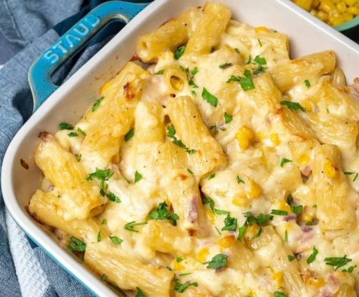 Creamy tuna pasta bake topped with melted cheese and herbs.