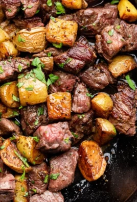 Garlic Butter Steak Bites with crispy potatoes on a plate