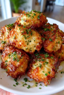 Garlic Parmesan Chicken Bites garnished with herbs on a serving plate