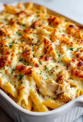 Garlic Parmesan Chicken Pasta Bake with melted cheese and herbs