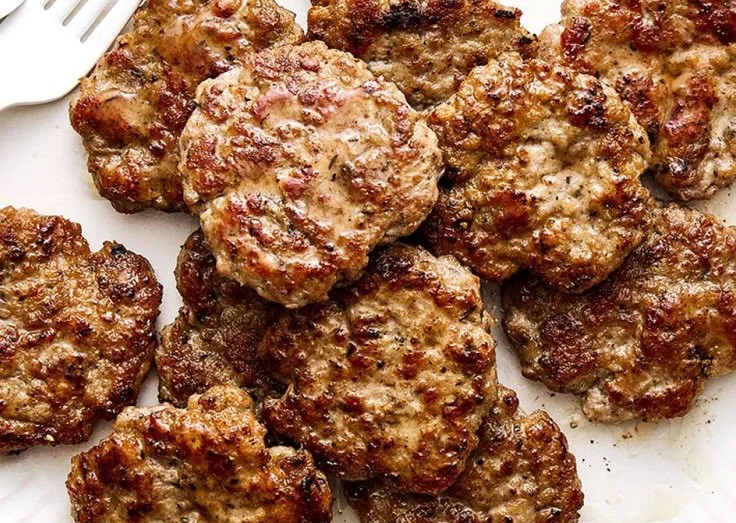 Gluten-Free Chicken Breakfast Sausage served on a plate with herbs
