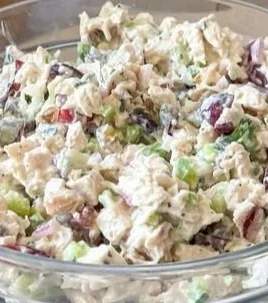 Bowl of healthy chicken salad without mayo, loaded with fresh vegetables.