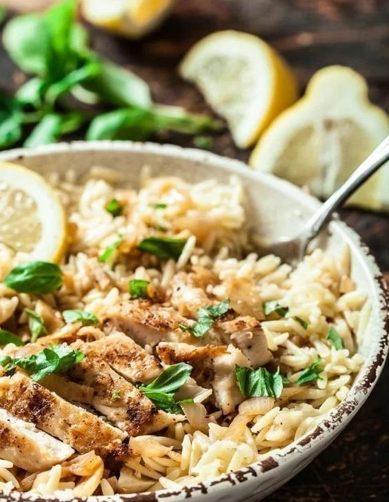 Delicious Lemon Basil Orzo with Chicken garnished with fresh basil leaves.