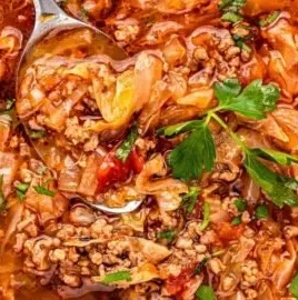 Bowl of low carb cabbage soup with fresh ingredients.
