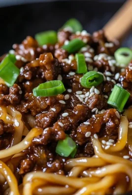 Plate of Mongolian Ground Beef Noodles garnished with green onions