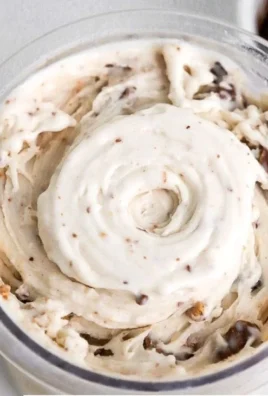 Moose Tracks Protein Ice Cream in a bowl with chocolate and peanut butter swirls