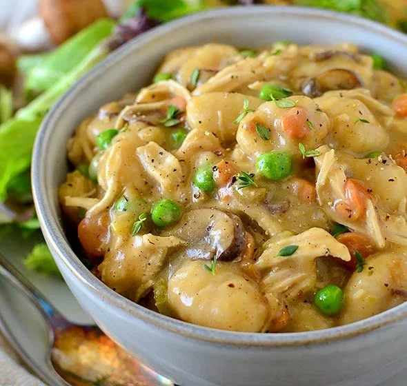 One pot gnocchi chicken pot pie with vegetables and herbs.