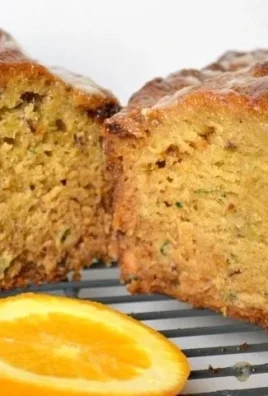 Slice of orange zucchini bread made with whole wheat and honey