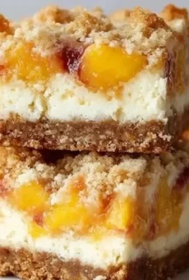 Delicious peach cobbler cheesecake bars with fresh peaches and a golden crust