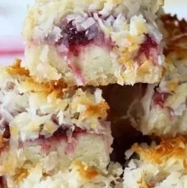 Delicious homemade Raspberry Coconut Bars on a wooden table