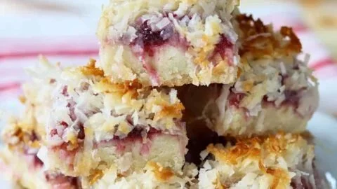 Delicious homemade Raspberry Coconut Bars on a wooden table