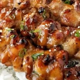 Grilled teriyaki chicken skewers served on a plate with vegetables